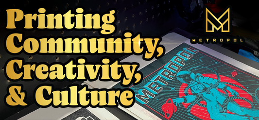 A colorful print featuring an astronaut and the word METROPOL beside bold yellow text: Printing Community, Creativity, & Culture, with the Metropol logo in the top right corner.