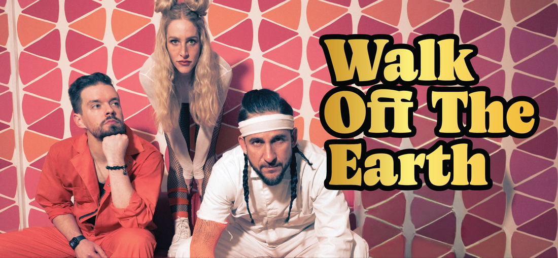 Three people pose in front of a retro pink and orange patterned wall. Bold yellow text reads Walk Off The Earth. One person wears orange, another white, and a third stands between them.